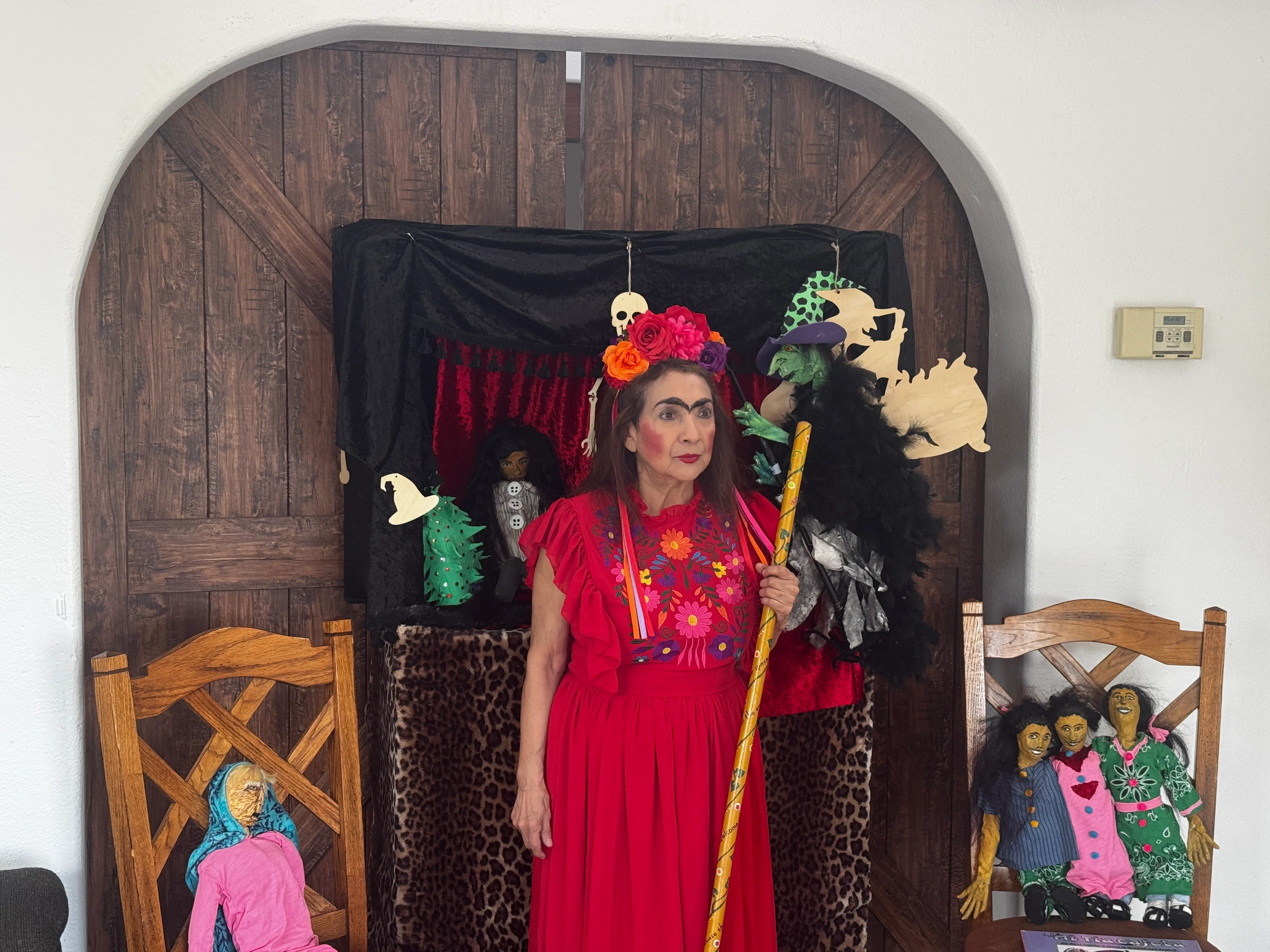 Nancy Perez Fugere in traditional Mexican attire with puppet stage