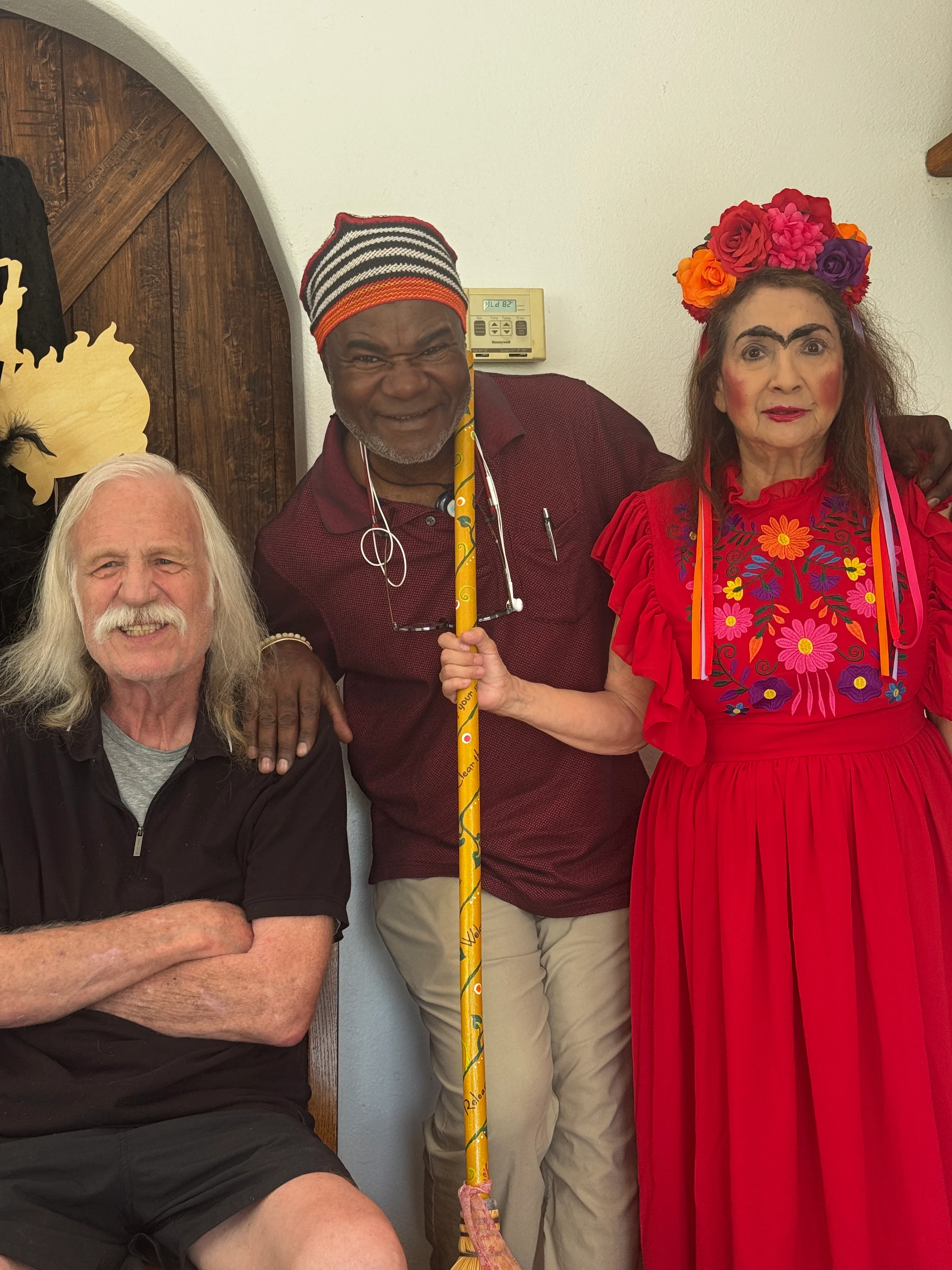 The creative team holding the magic broom